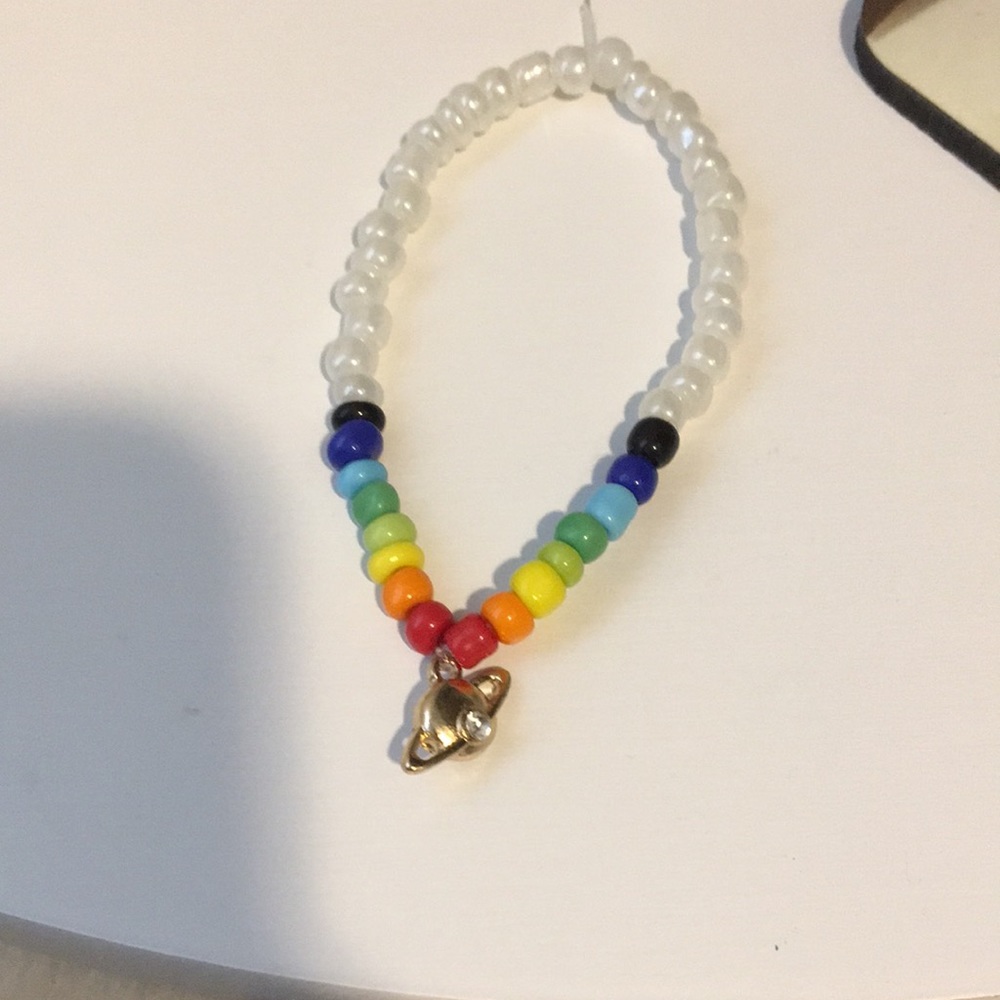 White and rainbow beaded bracelet with planetcharm